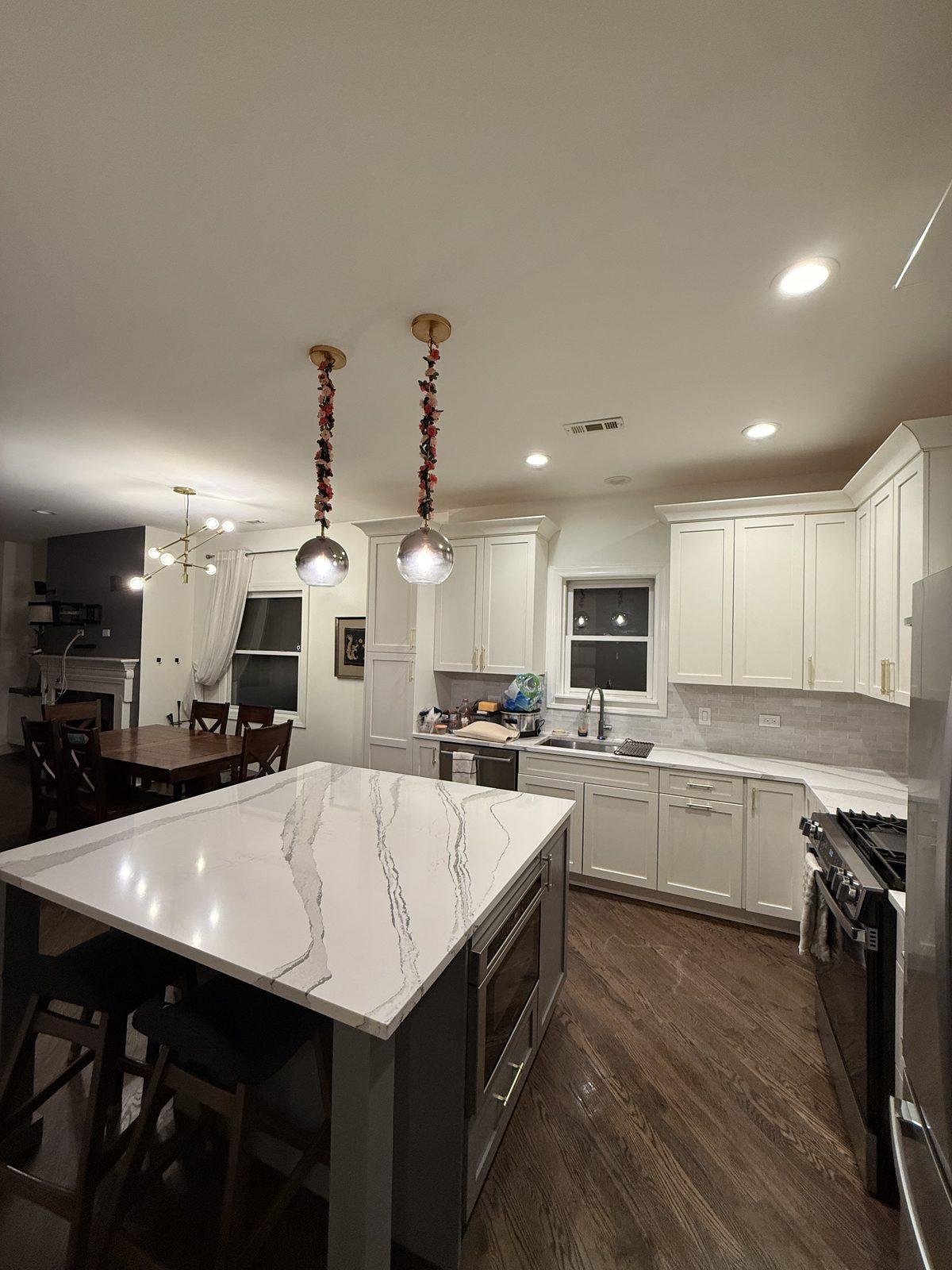 Clean kitchen with white cabinetry and quartz island