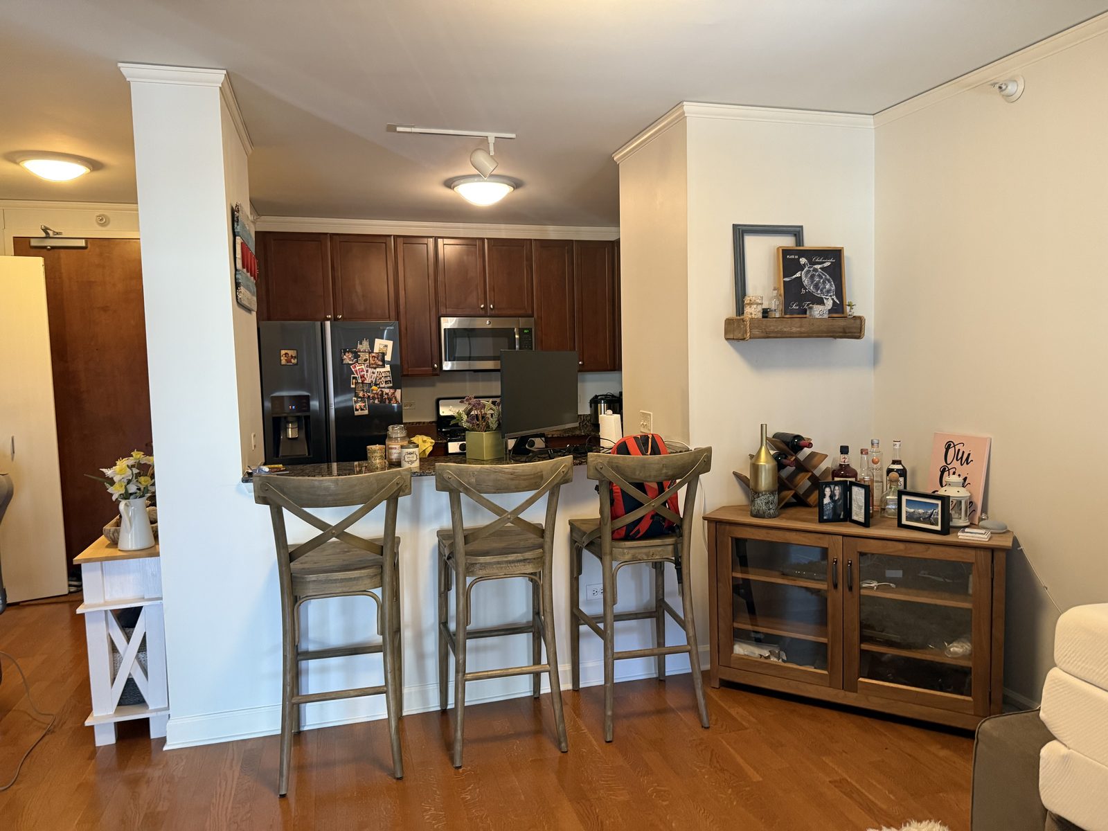 Clean kitchen and living area with bar seating